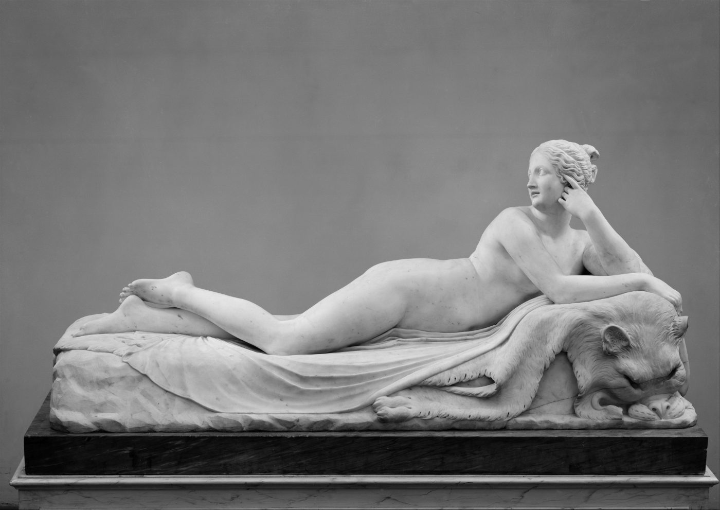 Canova's Reclining Naiad: a reclining figure in Carrara marble, the polished surface catching light along the length of the body.